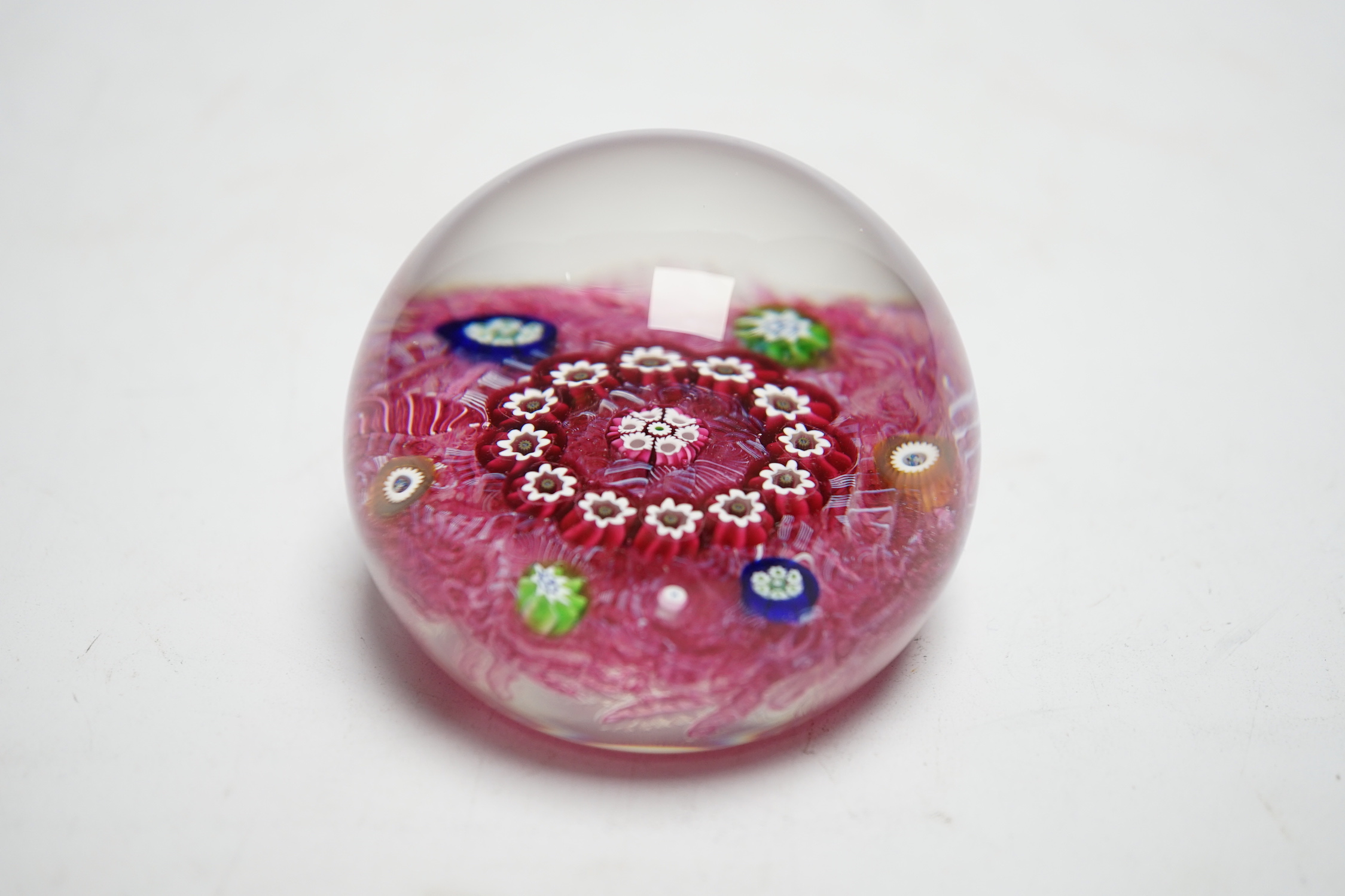 A Paul Ysart millefiori garland glass paperweight, Harland period, ‘H’ cane, with scrambled pink latticino ground, 6.5cm